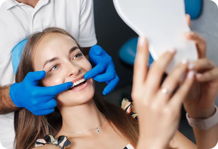 Woman looking at her teeth in mirror
