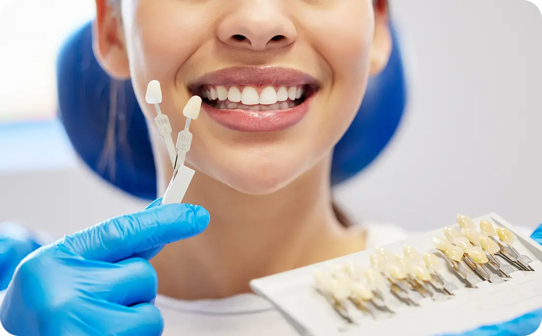 Woman smiling with veneers in front of her