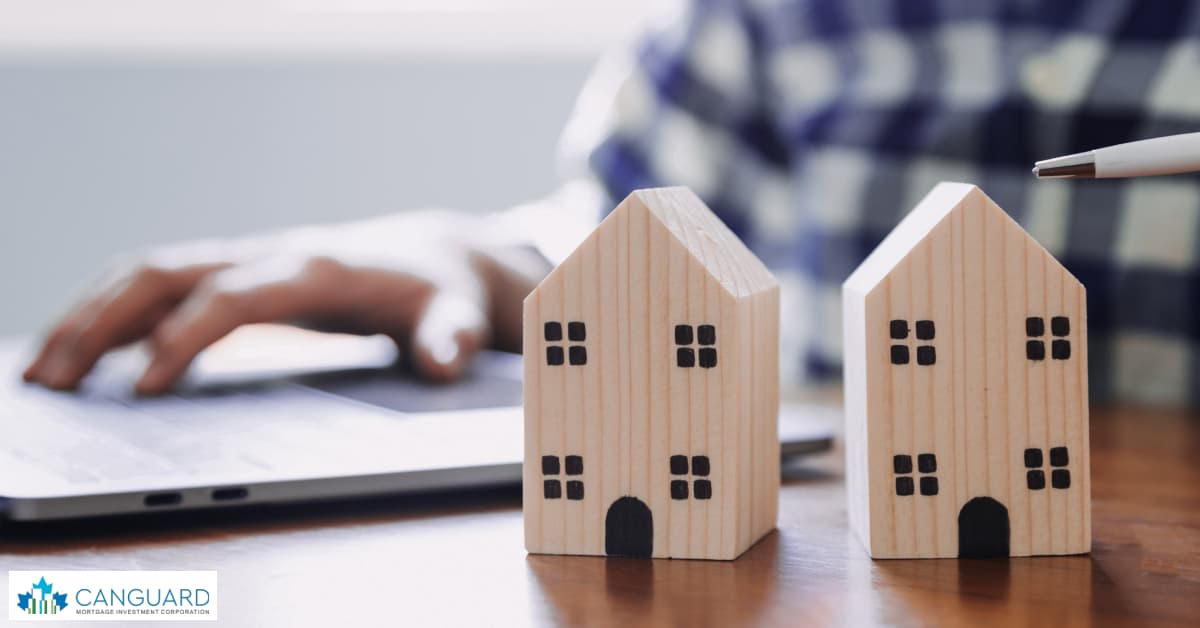 house models on a graph of British Columbia real estate market chart.
