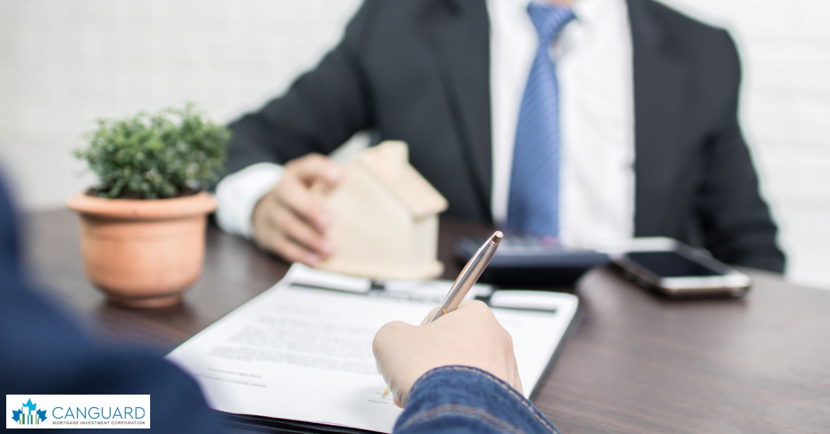 Two people are discussing reputable lenders in MIC and model houses are on the table.