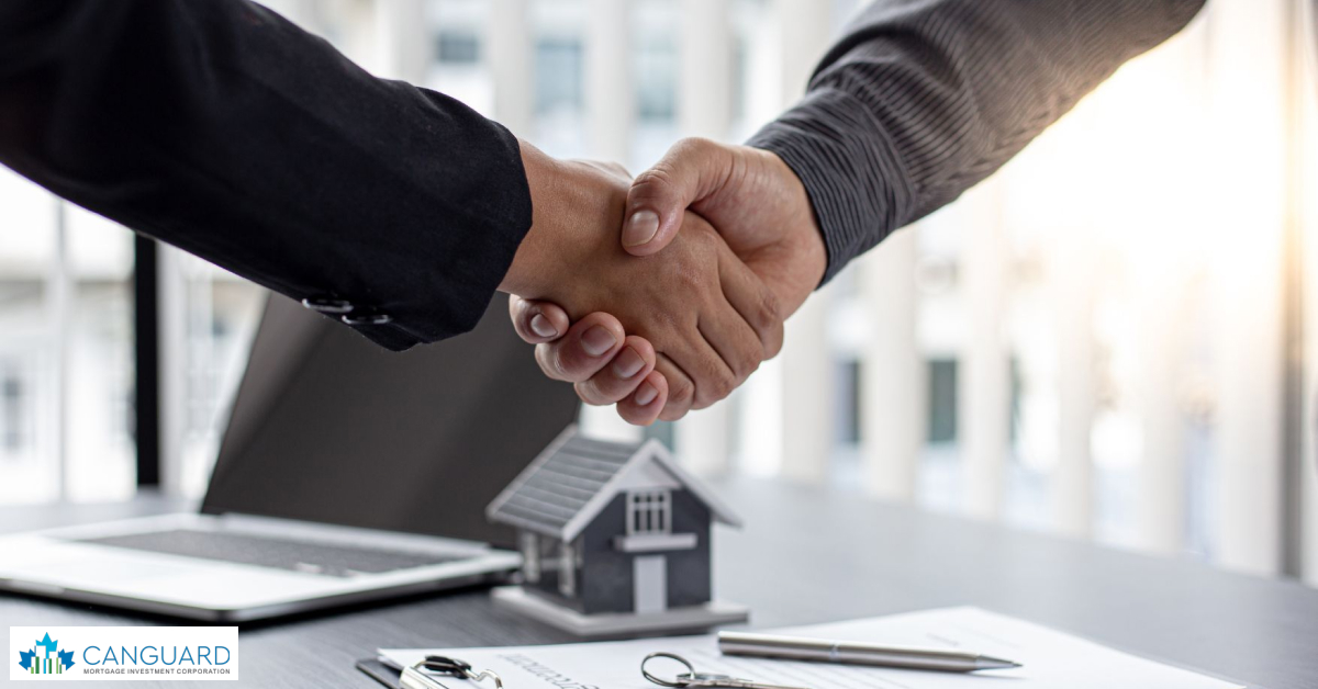 Two individuals shaking hands over a model of a house, representing choosing a reputable lender in MIC.