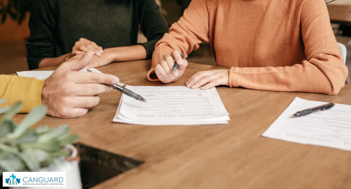 An image of a woman's hand with a calculator and charts showing the calculation of short-term real estate investment gains and losses.