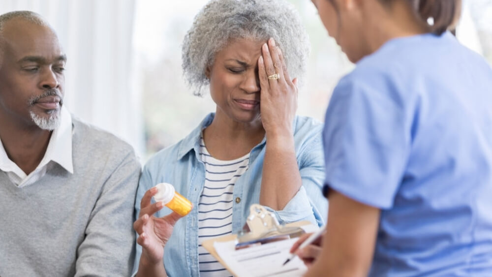 Upset senior woman talks with doctor about her eyebrow