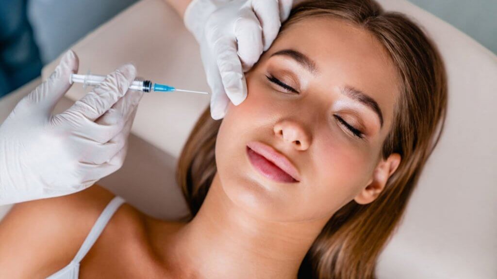 Young woman gets beauty facial Botox in salon