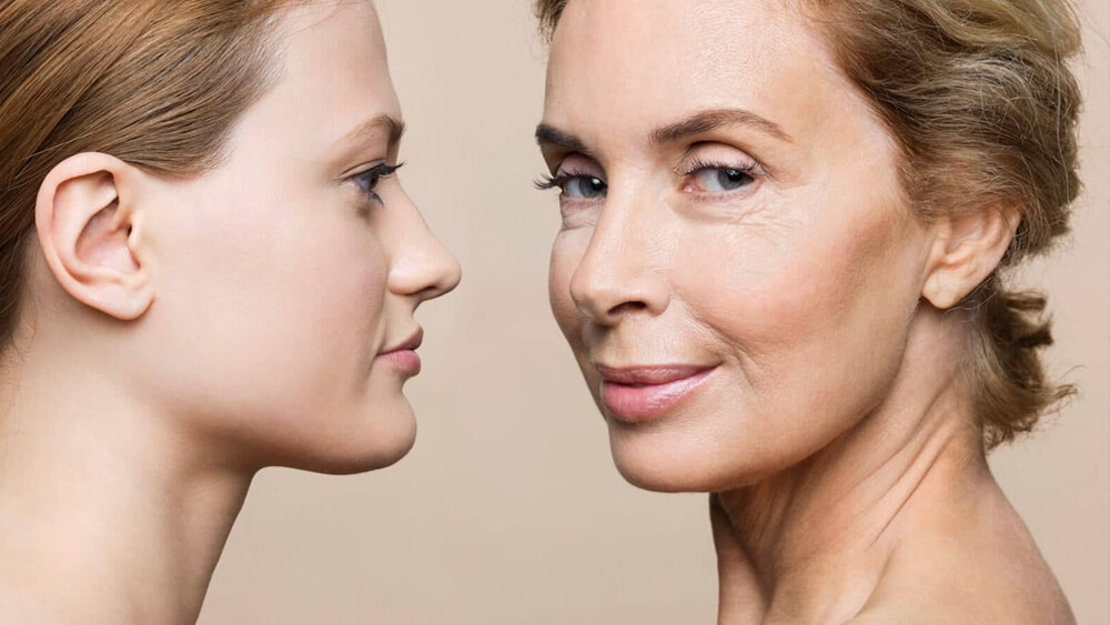 Young woman against old woman with sagging skin