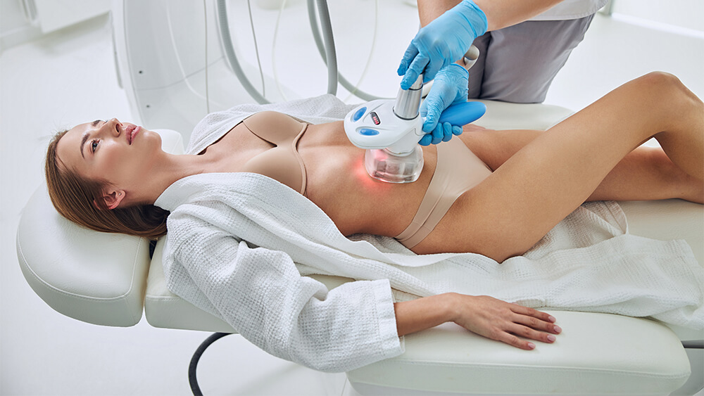 Woman lying on medical bed for body contouring