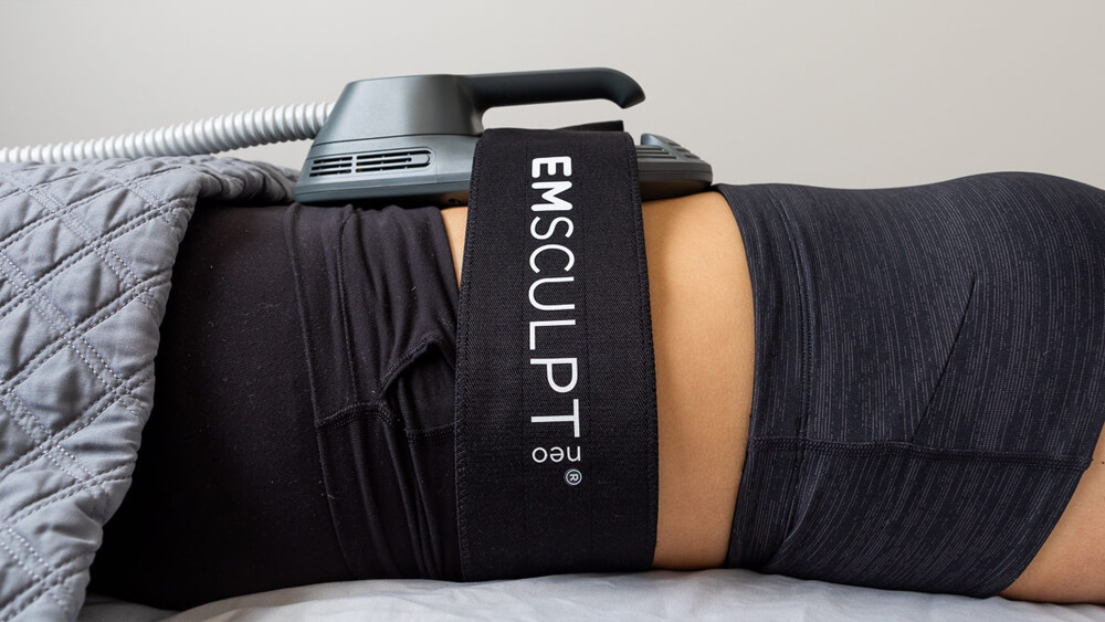 Woman under EmSculpt Neo