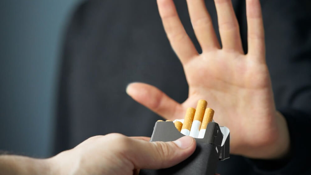 Stop smoking concept  and hand is refusing cigarette offer
