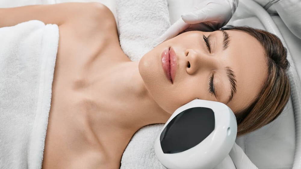 Woman receiving IPL procedure for removing brown spots