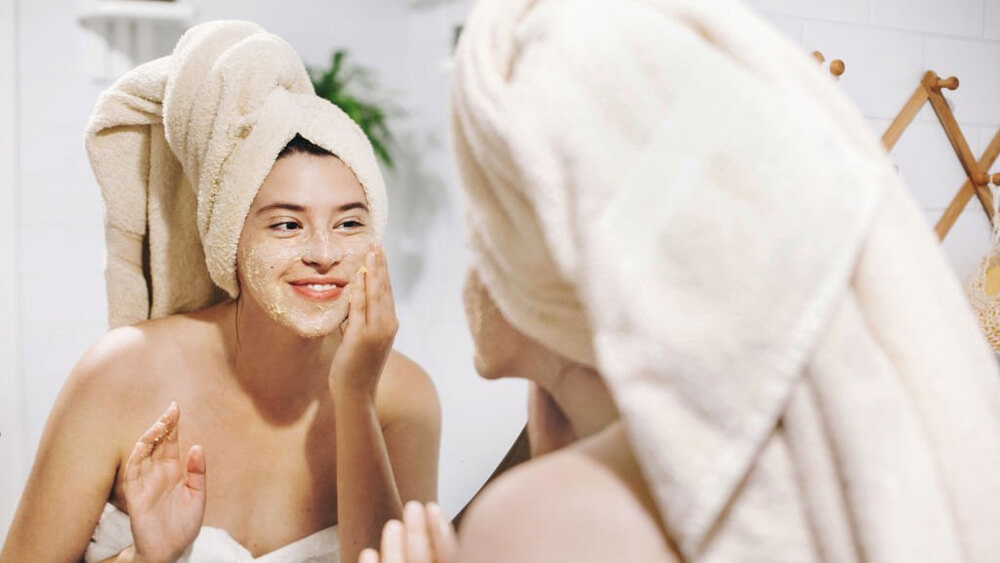 Woman making facial massage as skincare routine