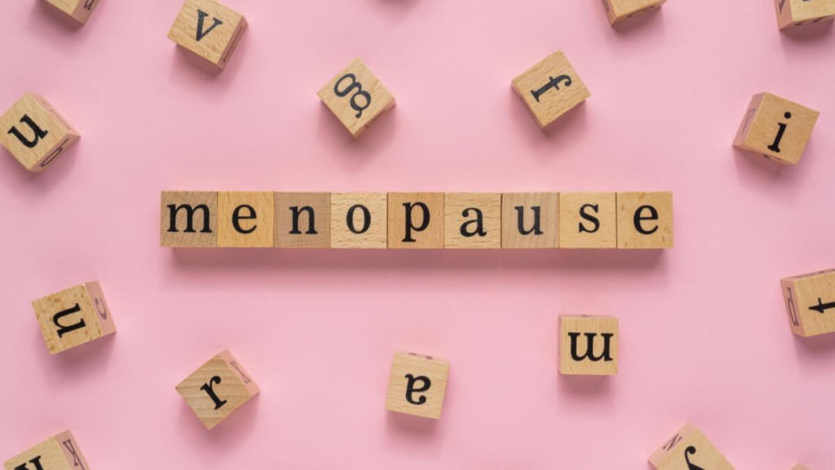 Menopause word on wooden block flat lay view