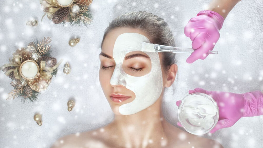 Doctor using face mask on the beautiful woman's skin