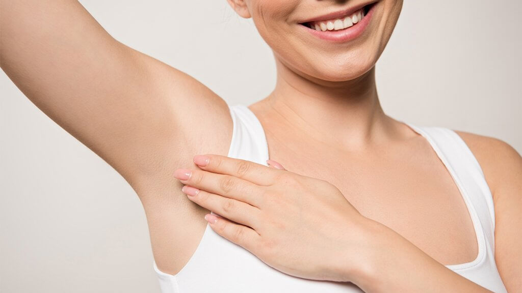 Smiling woman with clean underarms