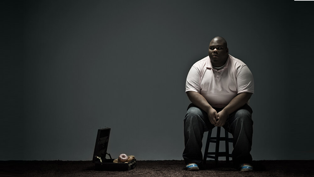 Overweight man and doughnuts in briefcase