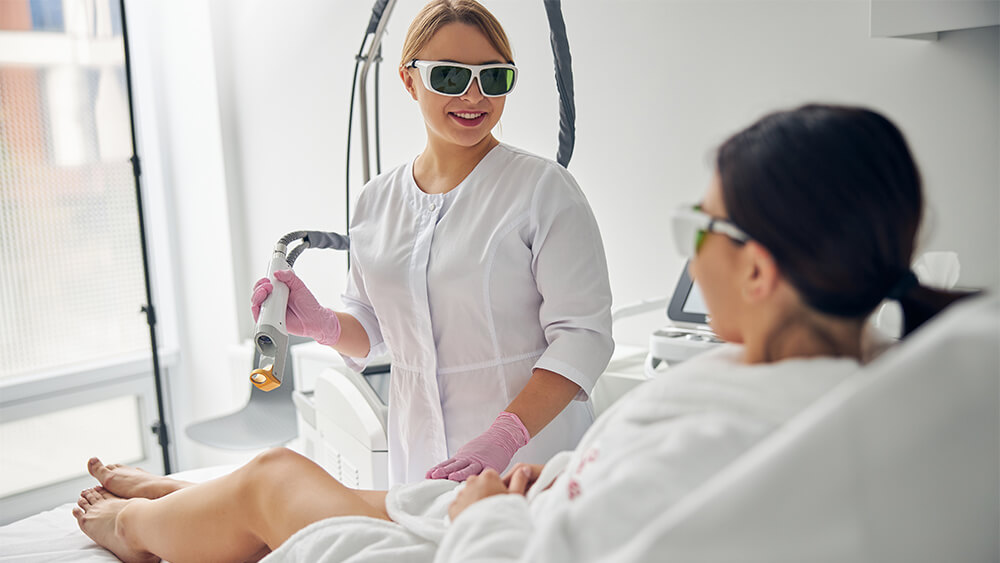 Cosmetologist holding a laser hair removal device