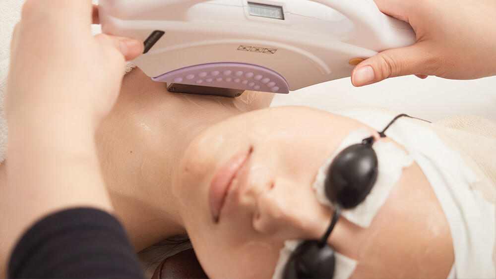 Young woman getting IPL treatment on her body