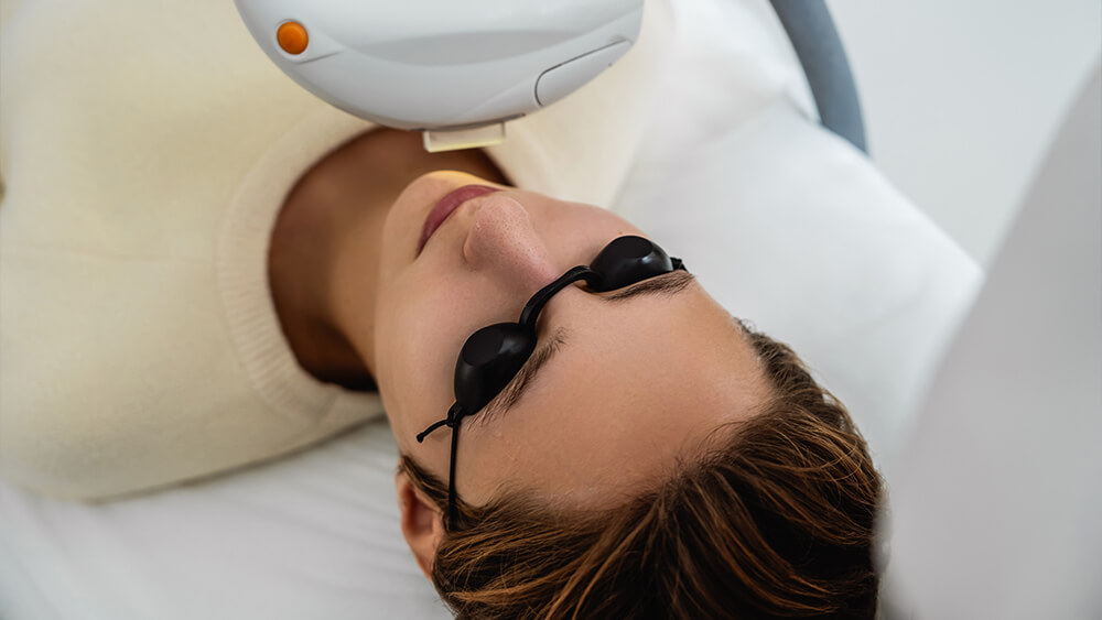 IPL is done on woman's face in a beauty salon