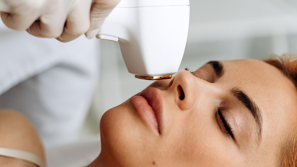 Closeup portrait of girl under laser treatment on her face