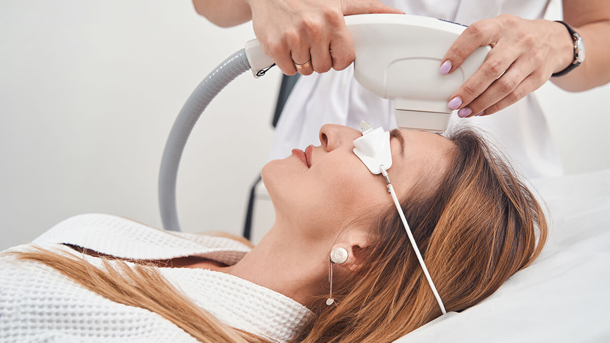 Woman getting IPL treatment on face