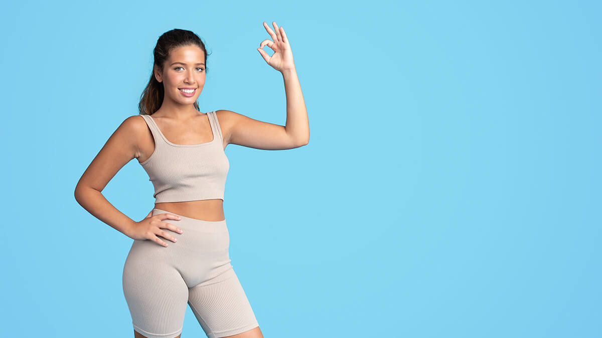 Cheerful young slim lady in sportswear