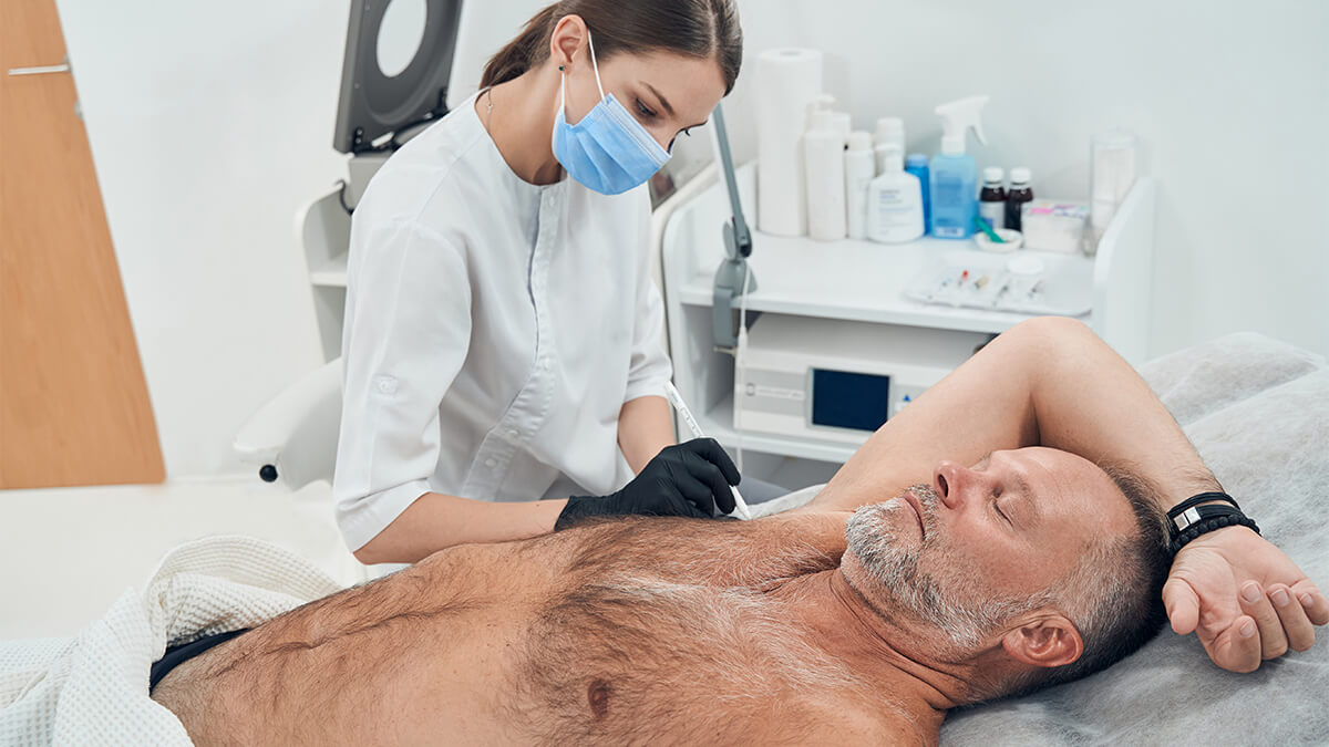 Man receiving underarm treatment in cosmetology